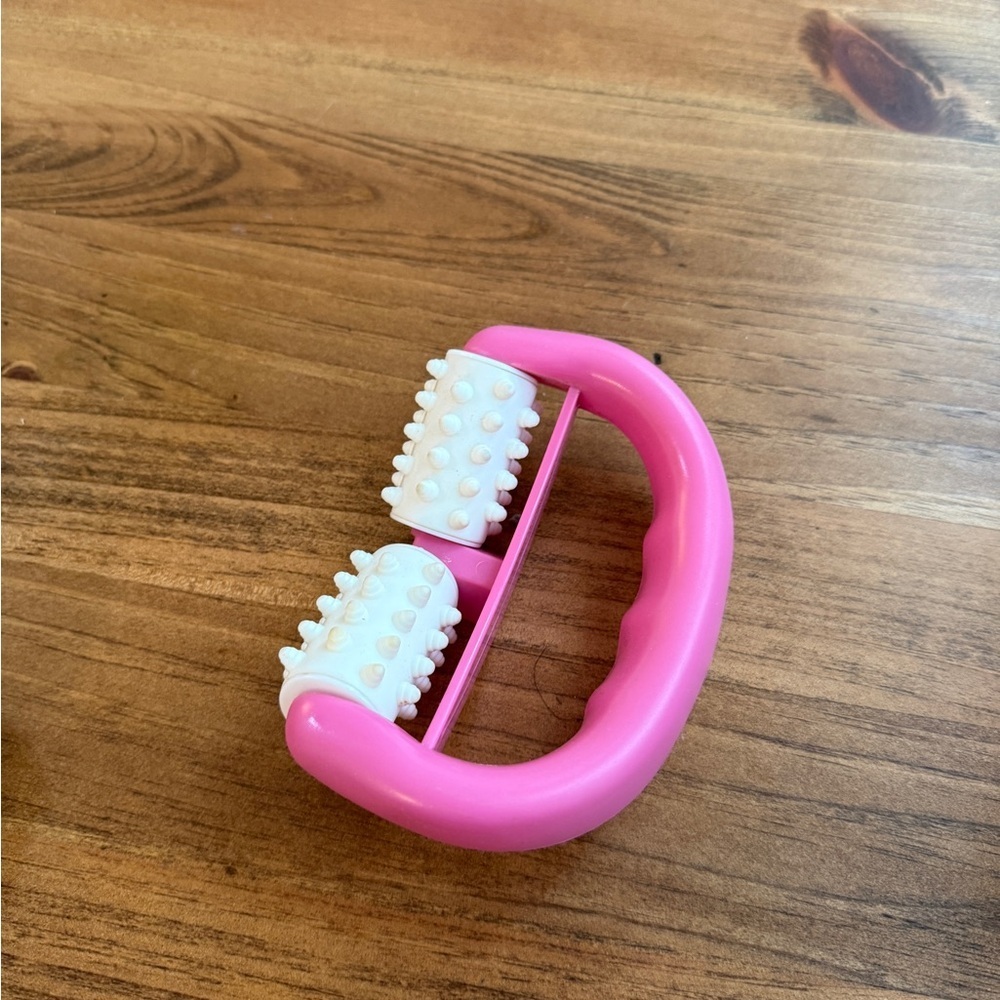 Handheld Pink Massage Roller with Textured White Rollers